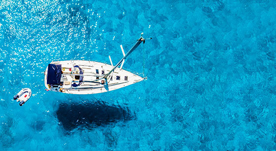 Upper photo of a boat at the clean blue water